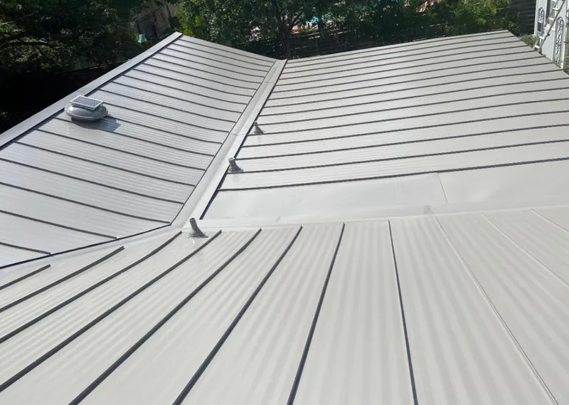 Solar attic fan installed on a metal roof for Roof Ventilation in Beloit